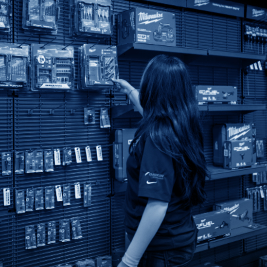 two warehouse associates near shipping terminal